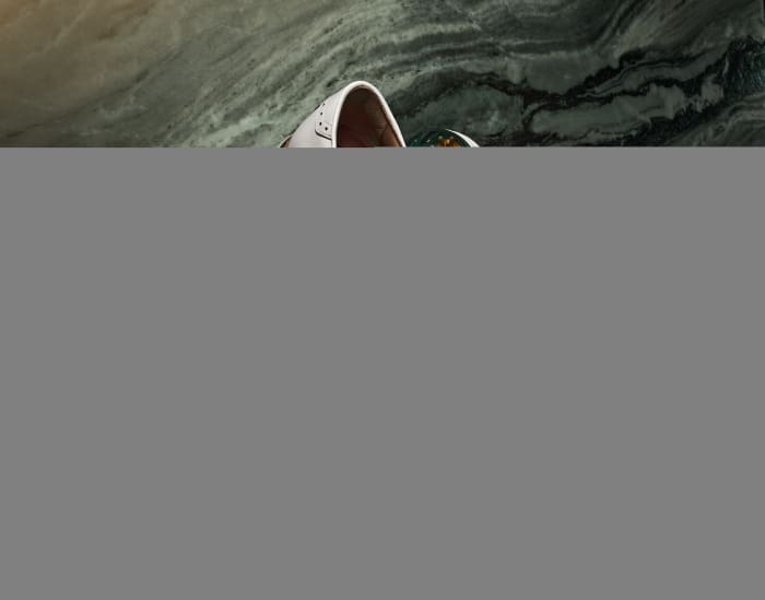 Side view of white FootJoy golf shoes.